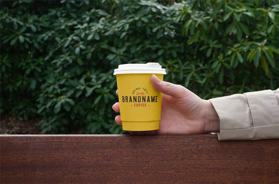 Hand Holding Coffee Cup PSD Mockup