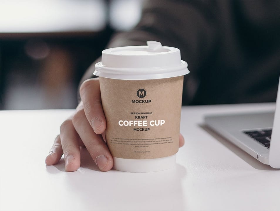 Free Person Holding Kraft Coffee Cup Mockup Design