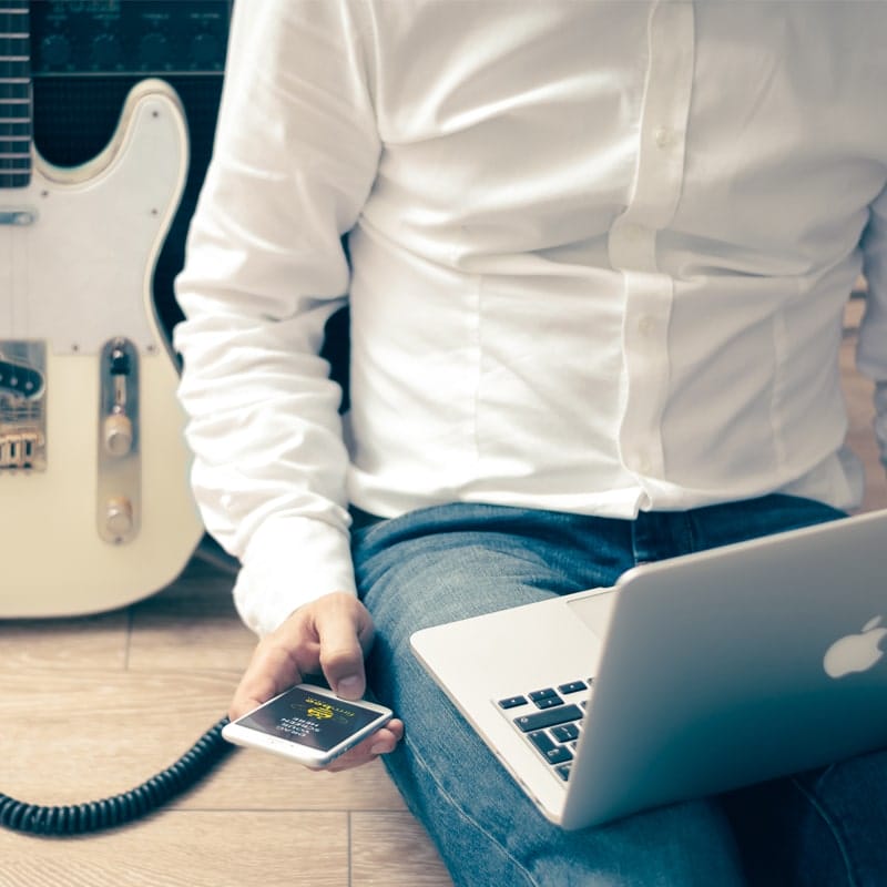 Man with Guitar & Apple Devices Mockup PSD