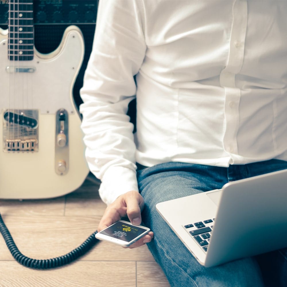 Man with Guitar & Apple Devices Mockup PSD