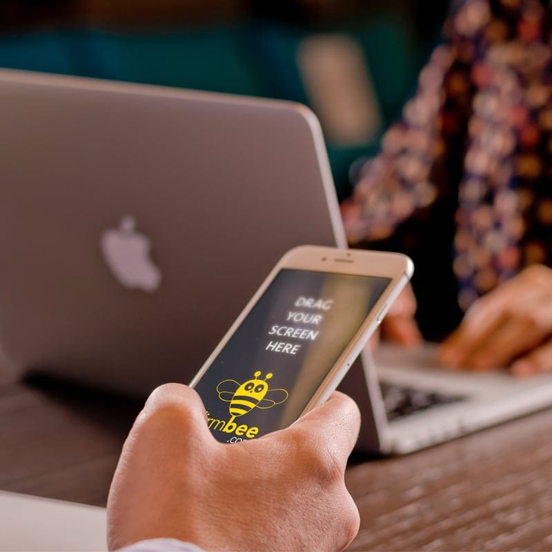 iPhone on Man's Hand Free Mockup PSD