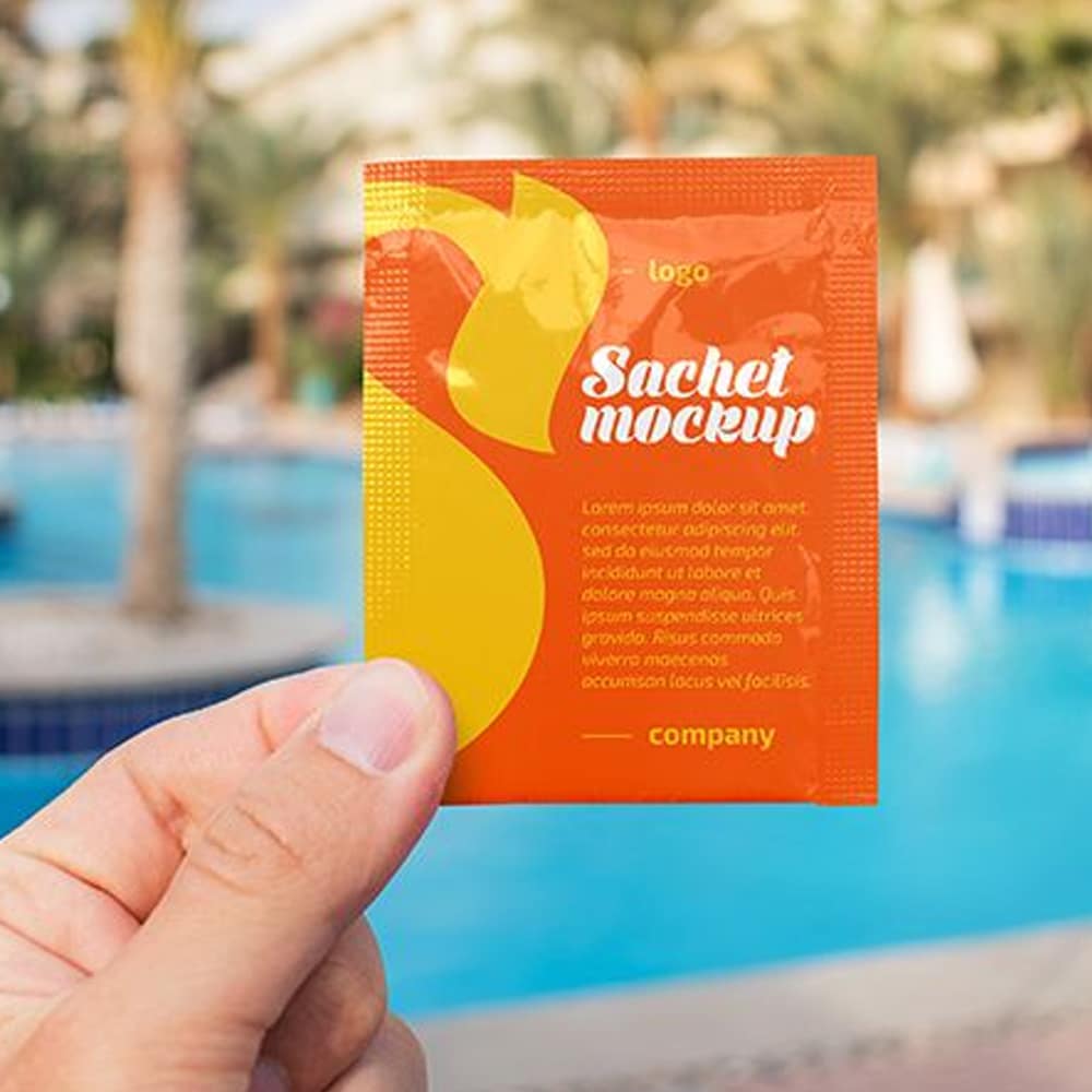 Free Sachet in a Hand Mockup