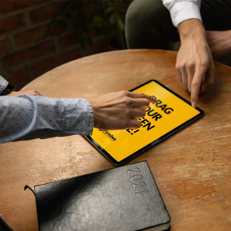 Man and Woman Discuss and use Apple iPad Air Free Mockup PSD