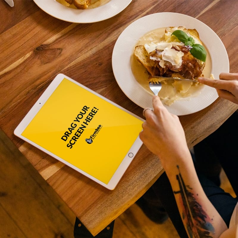 Woman With Tattoo And iPad Eats Lunch Free Mockup PSD