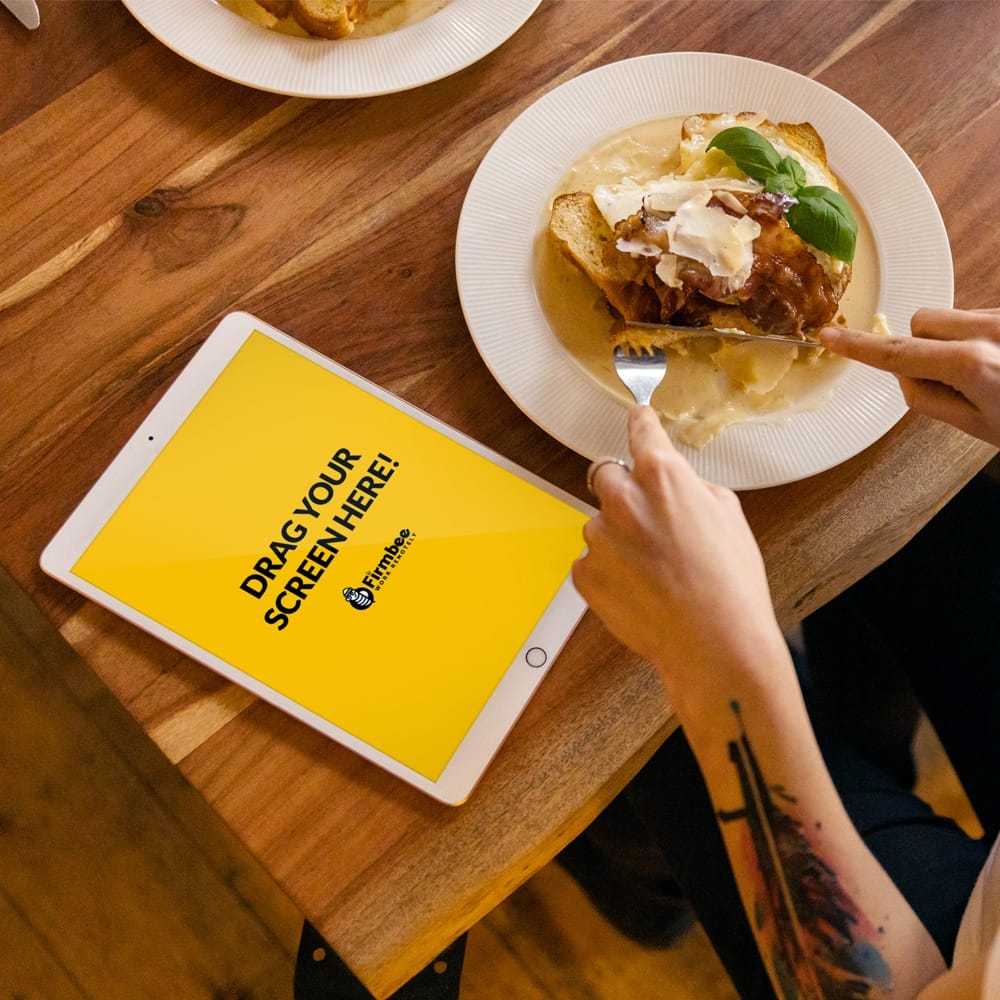 Woman With Tattoo And iPad Eats Lunch Free Mockup PSD