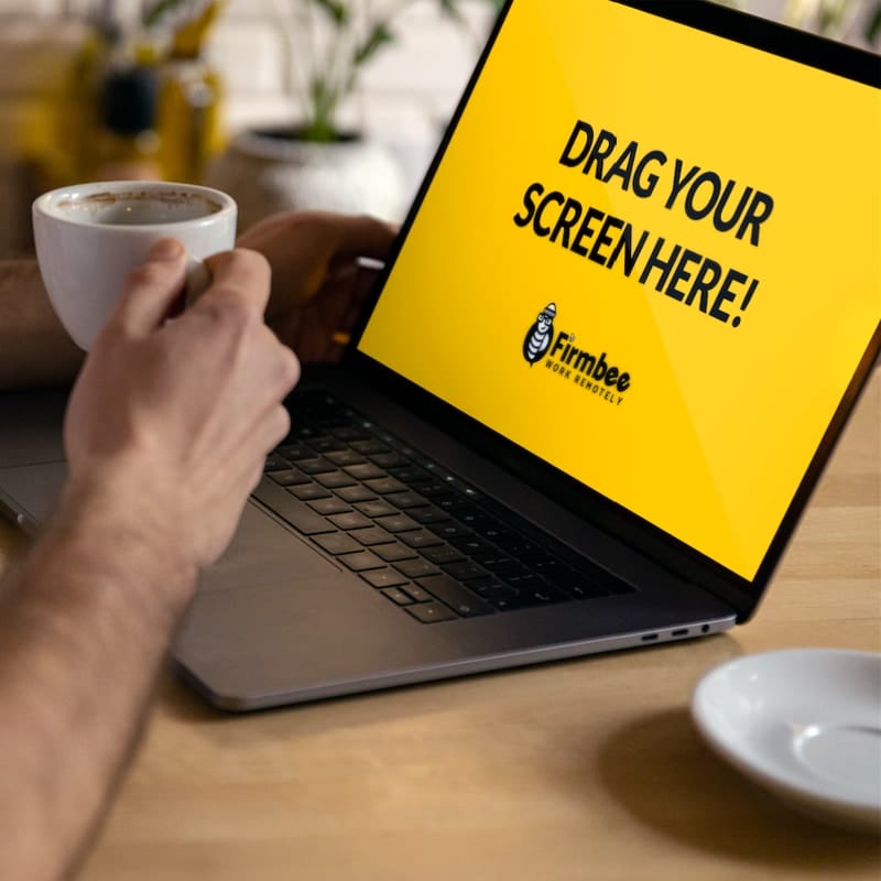 Man Drinks Coffee While Working On Apple MacBook Free Mockup PSD