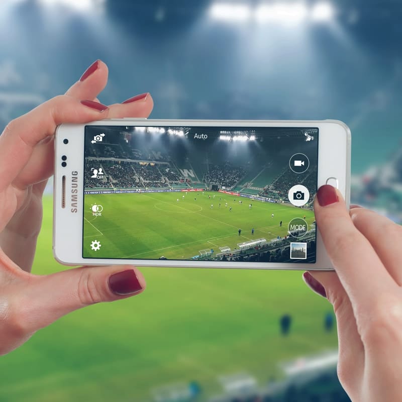Woman Uses Mobile On The Football Stadium Free Mockup PSD