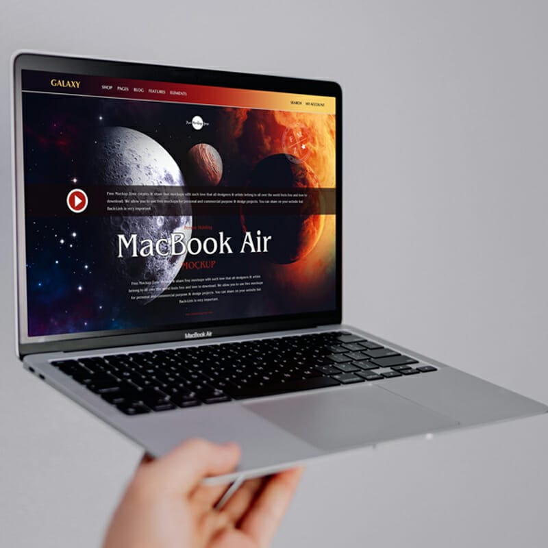 Free Person Holding MacBook Air Mockup