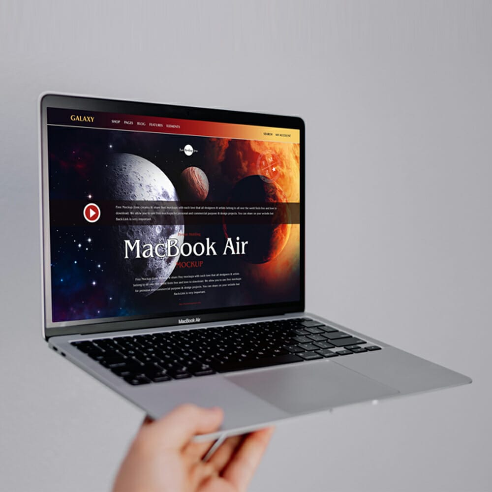Free Person Holding MacBook Air Mockup