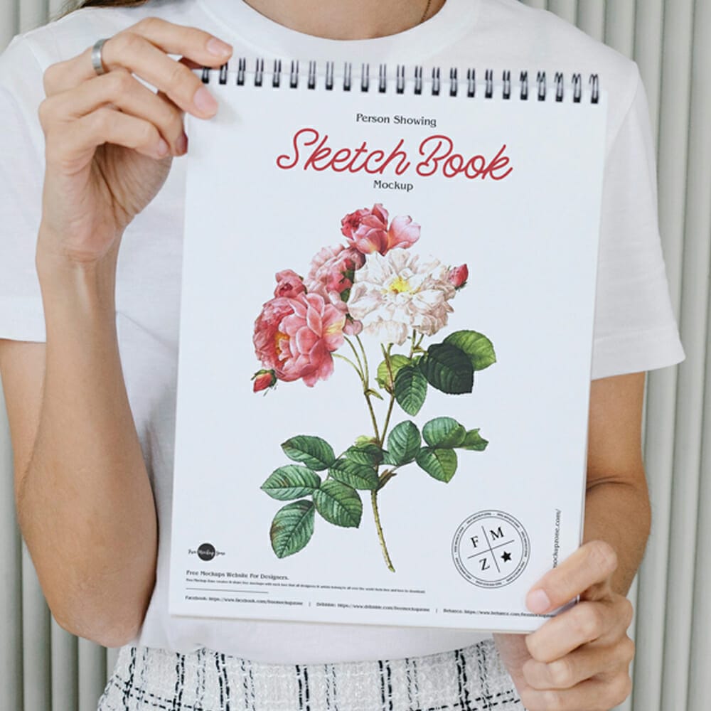 Free Person Showing Sketch Book Mockup