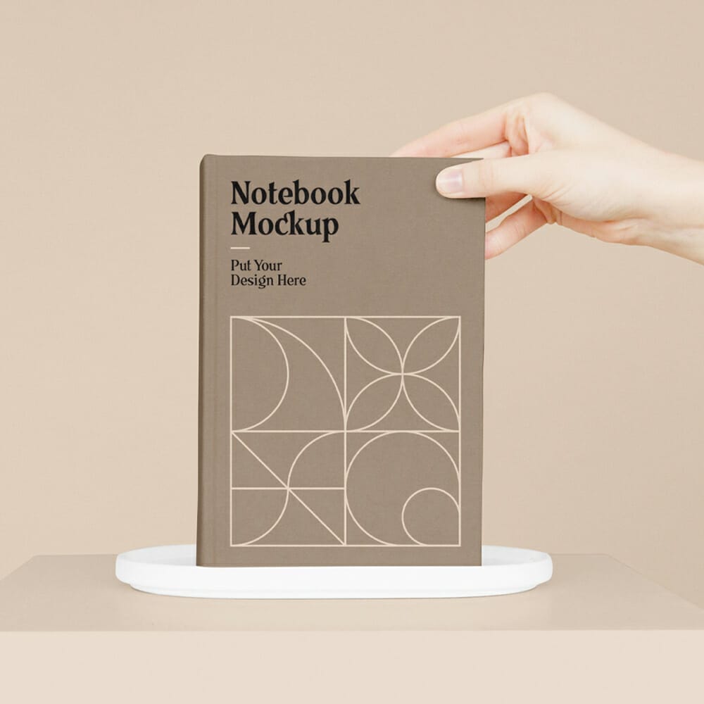 Notebook With Hand Mockup