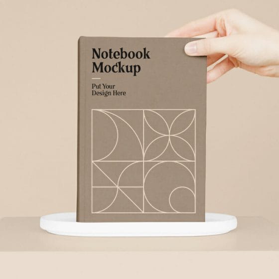 Notebook With Hand Mockup 1