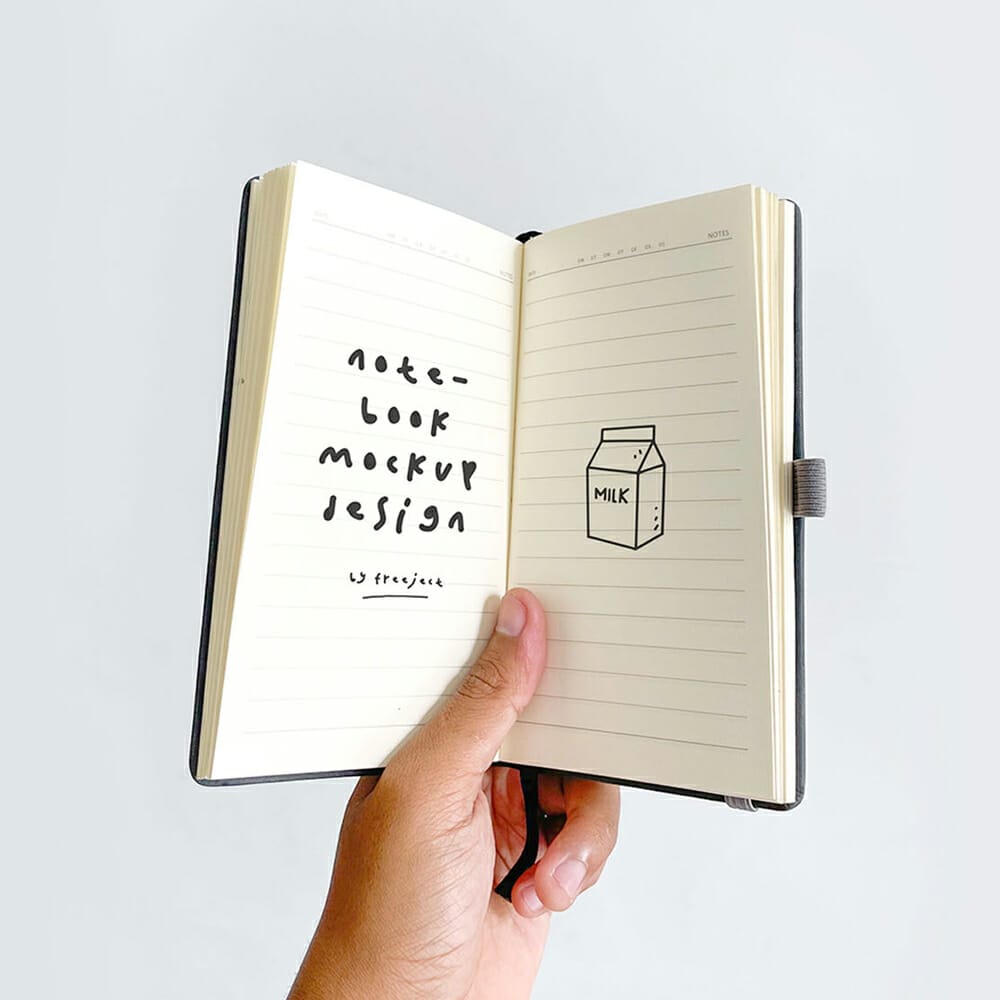 Free Hand Held Notebook Mockup Design