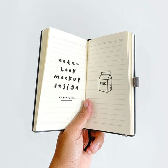 Free Hand Held Notebook Mockup Design