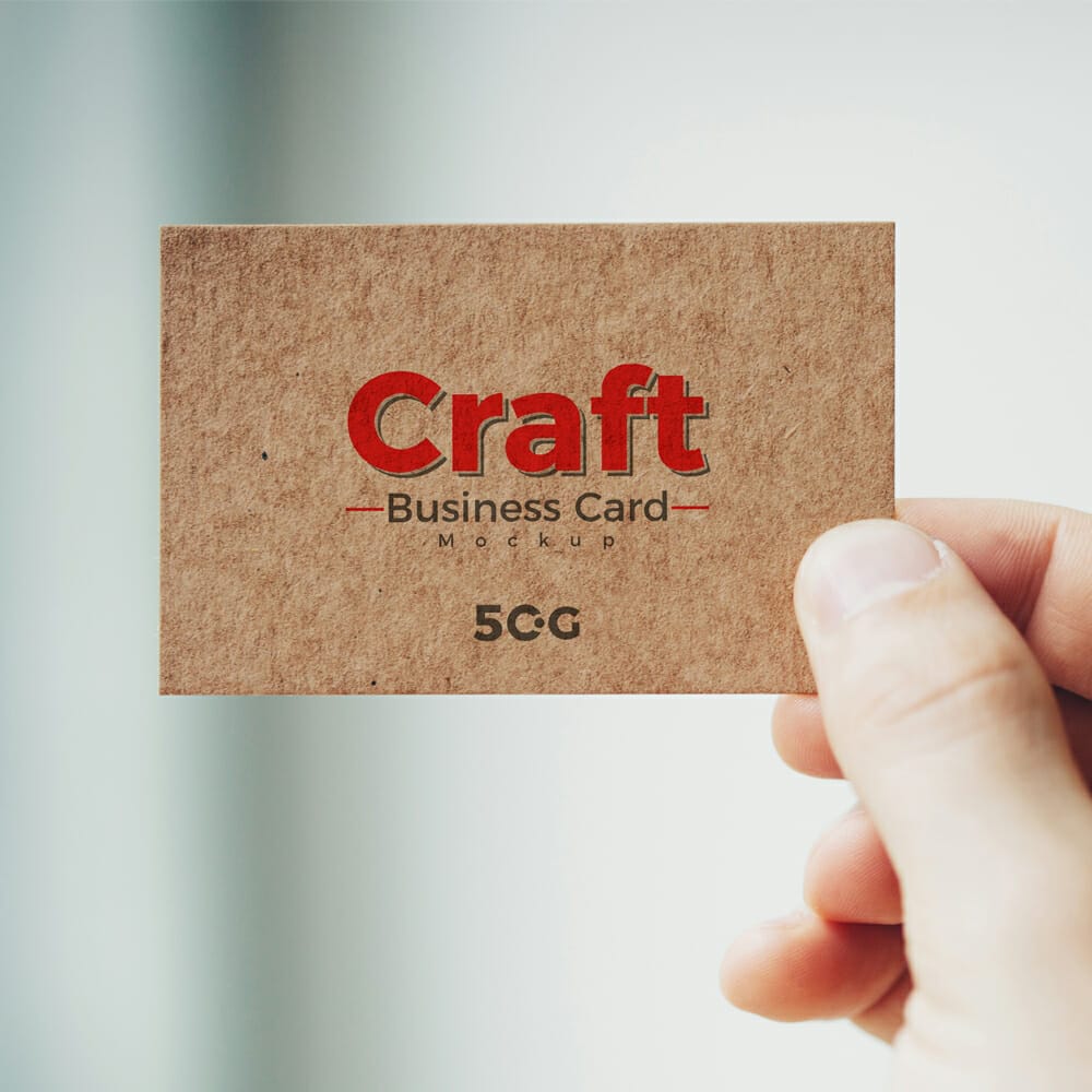 Free Man Holding Craft Business Card Mockup PSD