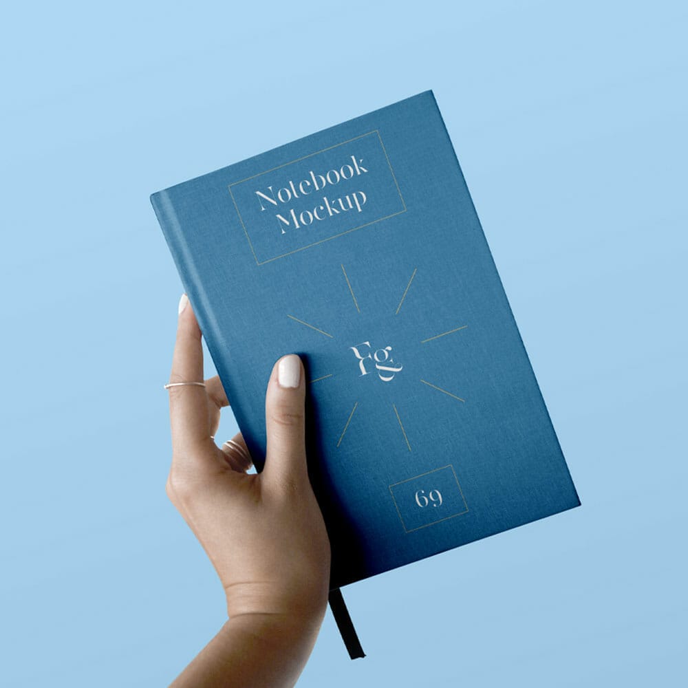 Hard Cover Notebook With Hand Mockup