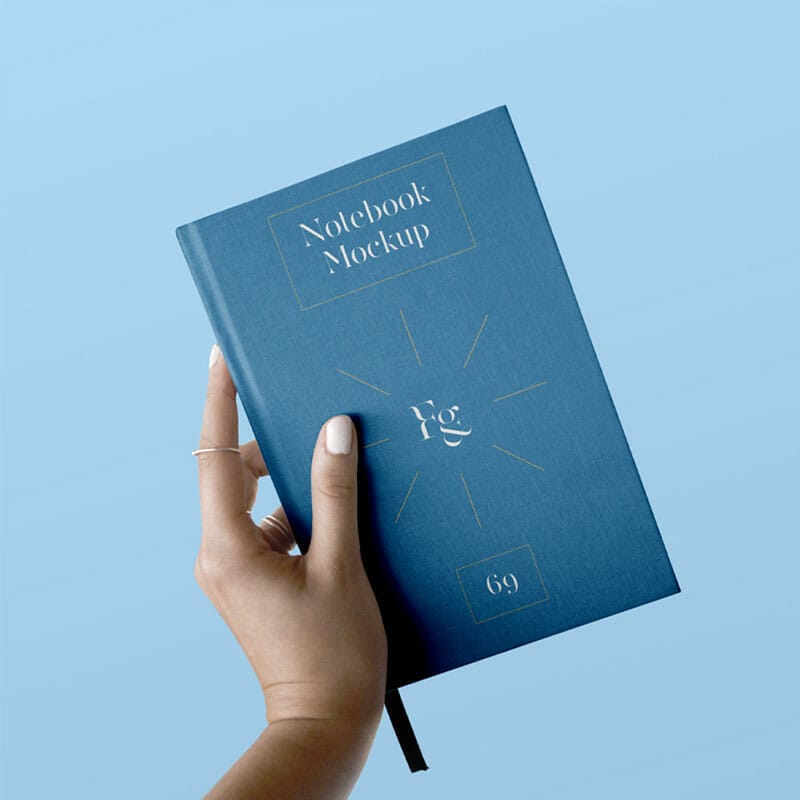 Hard Cover Notebook With Hand Mockup