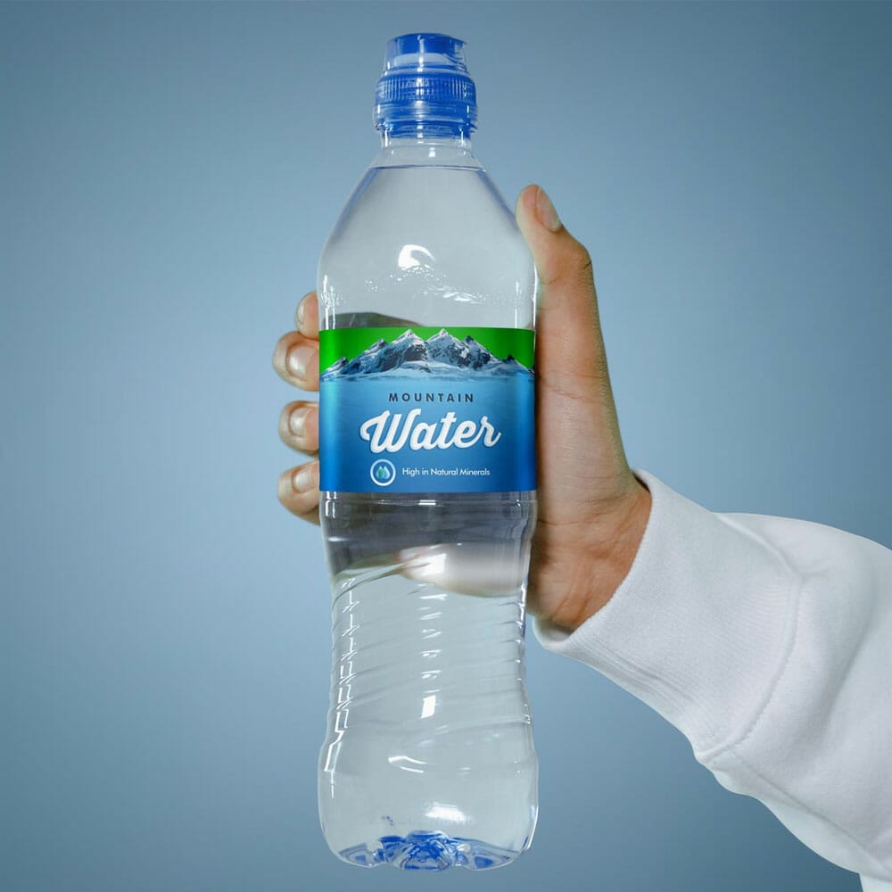 Free Hand Holding Water Bottle Label Mockup PSD