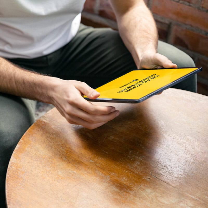 Man Uses Apple iPad Air In A Cafe Free Mockup