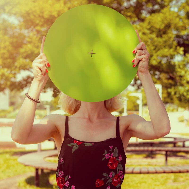 A Woman Holding A Round Banner In The Park Free Mockup