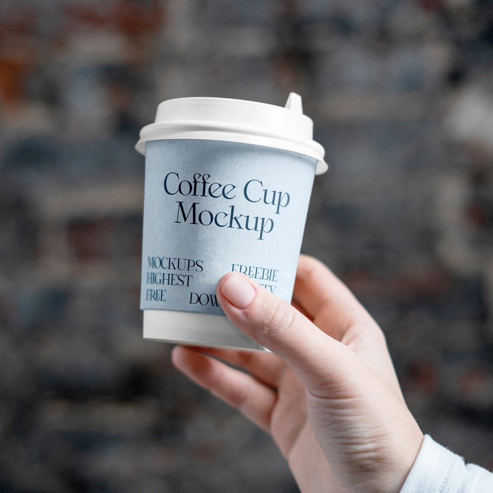 Free Coffee Cup In Hand Mockup PSD