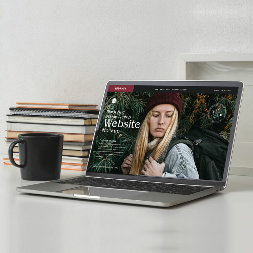 Free Black Mug Beside Laptop Website Mockup PSD