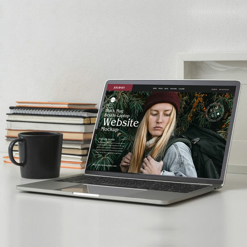 Free Black Mug Beside Laptop Website Mockup PSD