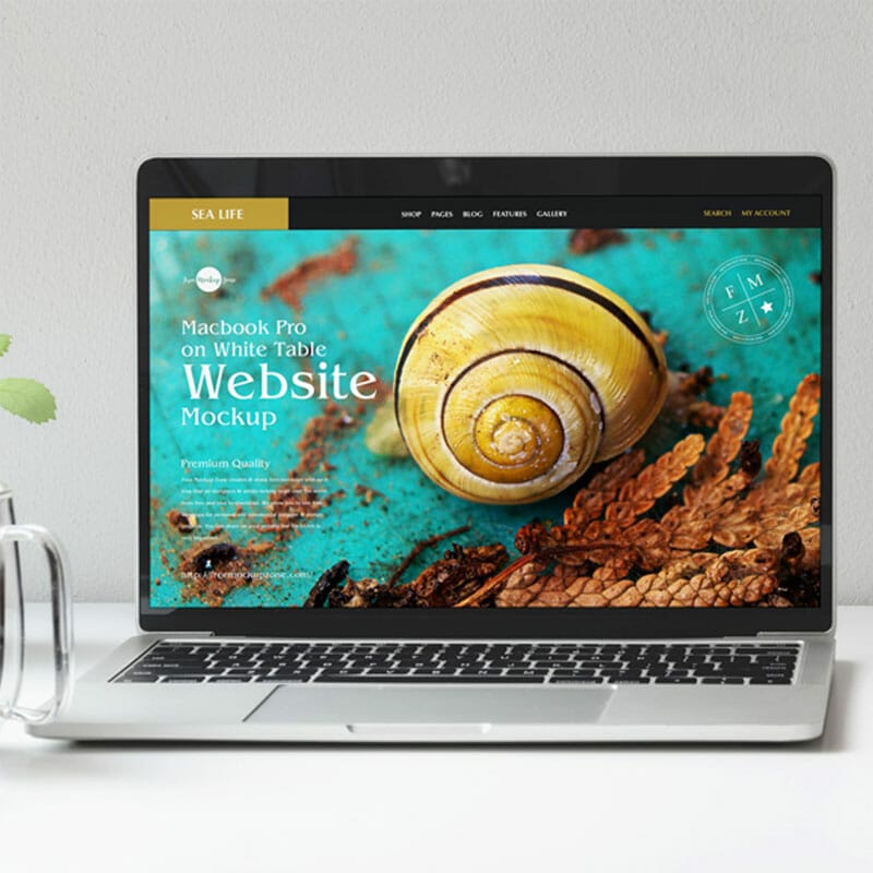 Free MacBook Pro On White Table Website Mockup