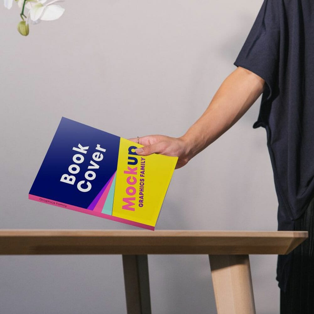 Free Book Cover In Hand Mockup PSD