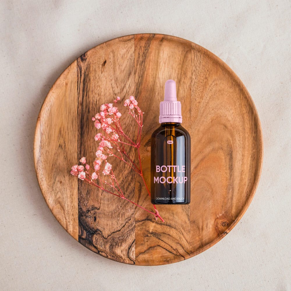Free Dropper Bottle On Wooden Plate Mockup PSD