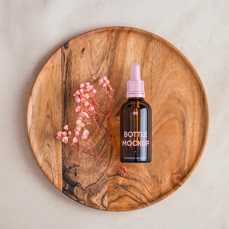 Free Dropper Bottle On Wooden Plate Mockup PSD
