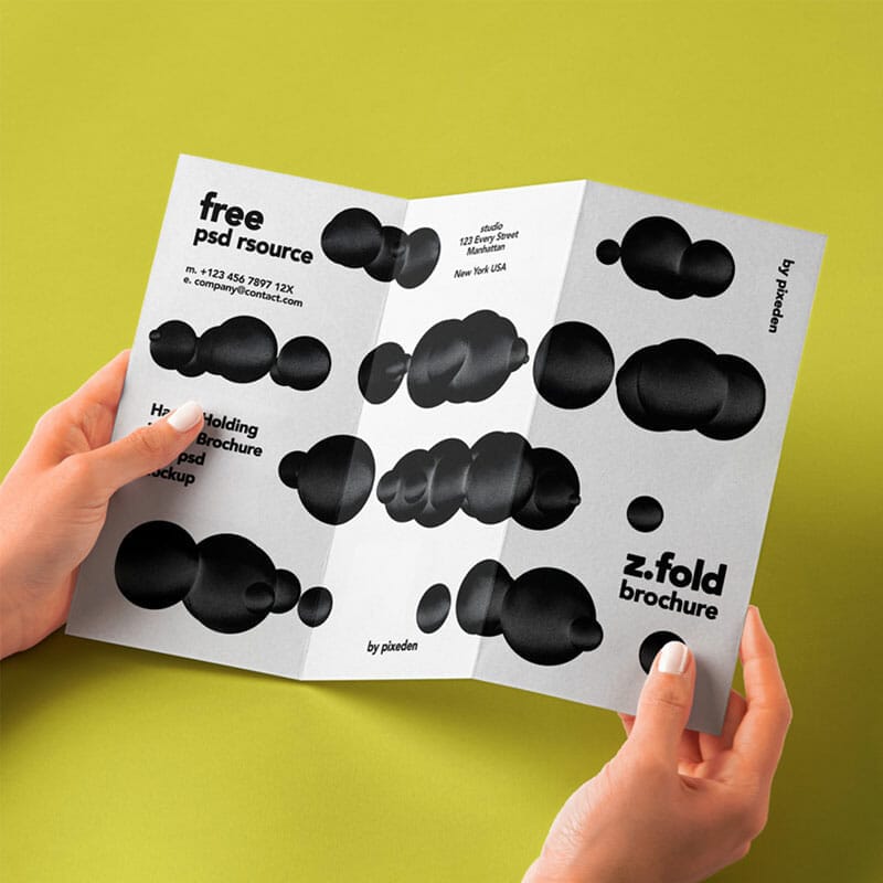 Free Hand Holding Folded PSD Brochure Mockup
