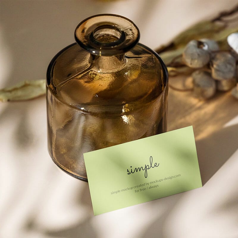 Free Business Card With Dark Bottle Mockup PSD