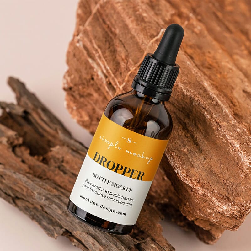 Free Dropper Bottle On The Rock Mockup PSD