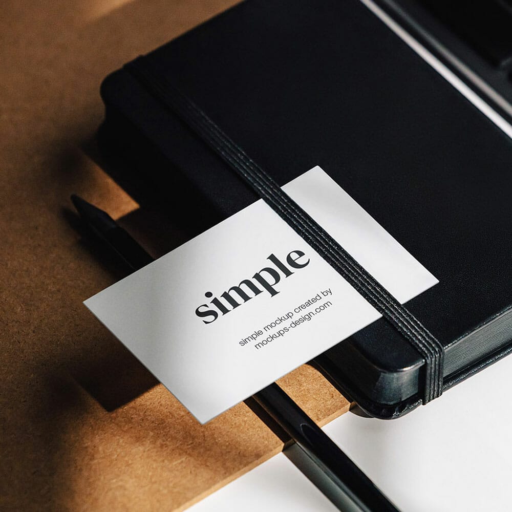Free Business Card On The Black Notepad PSD