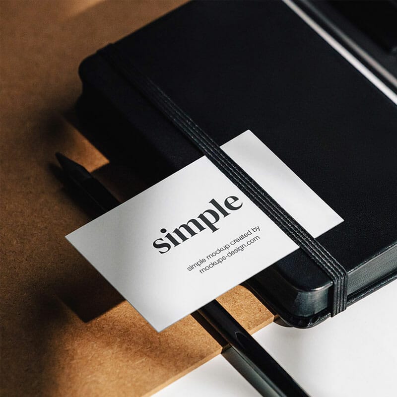 Free Business Card On The Black Notepad PSD