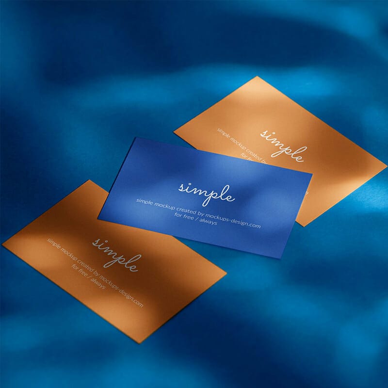 Three Business Cards On Blue Background Mockup PSD