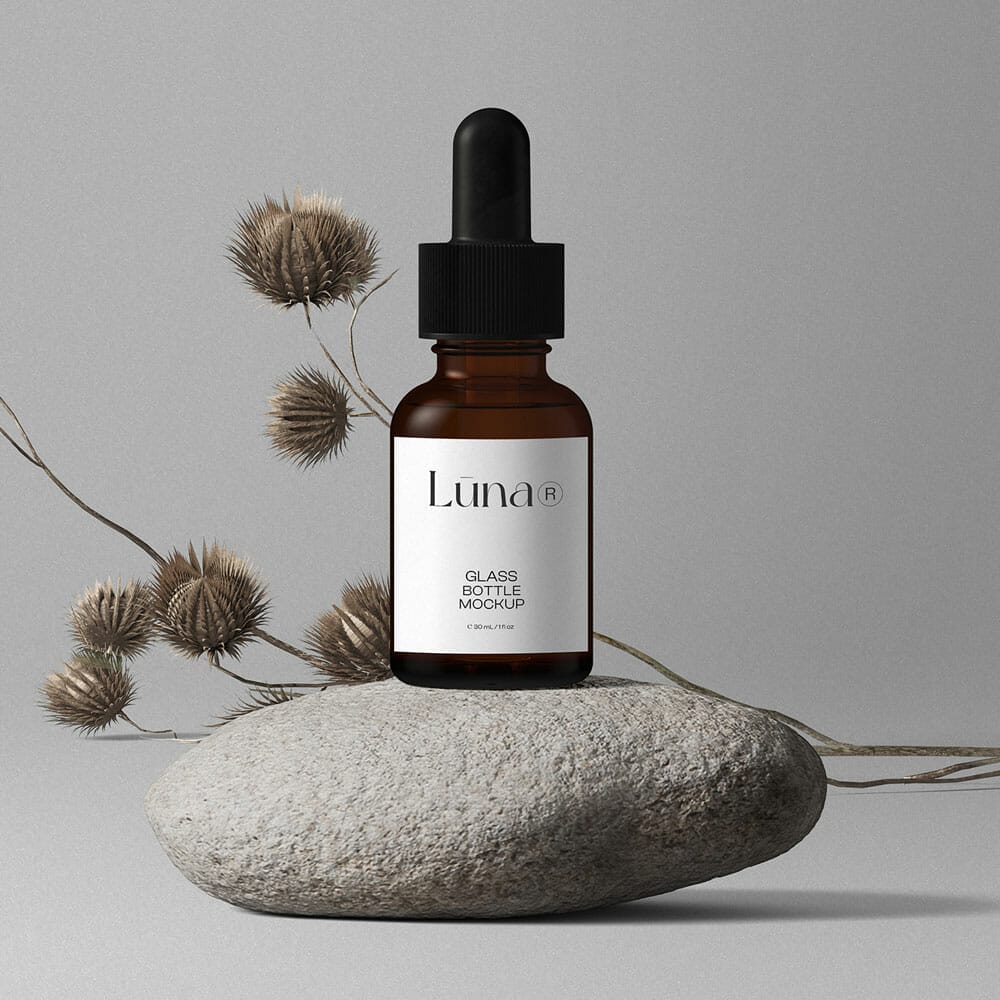 Free Cosmetic Bottle Mockups On Stones Front View PSD