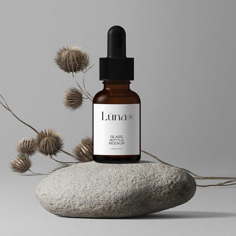 Free Cosmetic Bottle Mockups On Stones Front View PSD