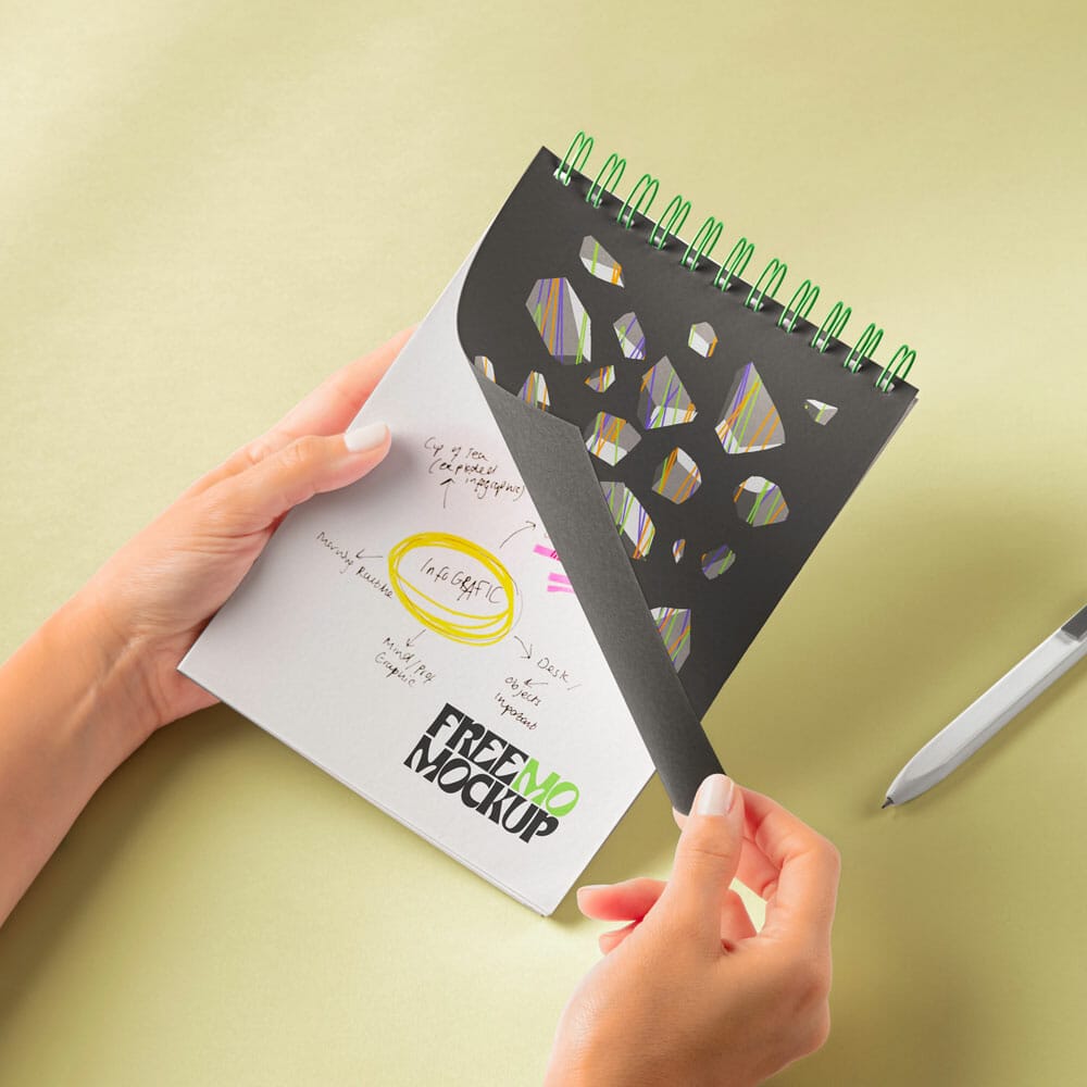 Free Hands Holding Spiral Notebook PSD Mockup