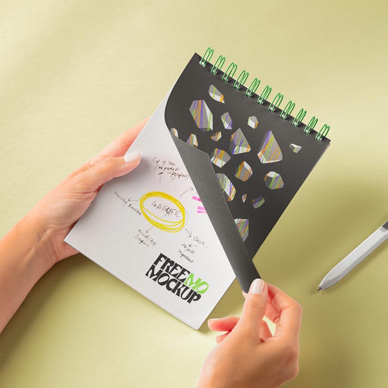 Free Hands Holding Spiral Notebook PSD Mockup