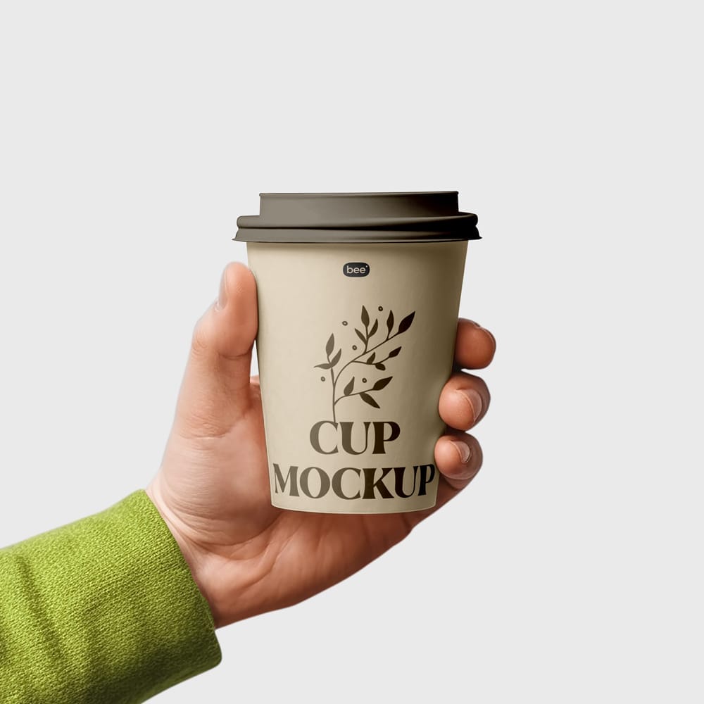 Free Medium Paper Cup in Hand Mockup PSD