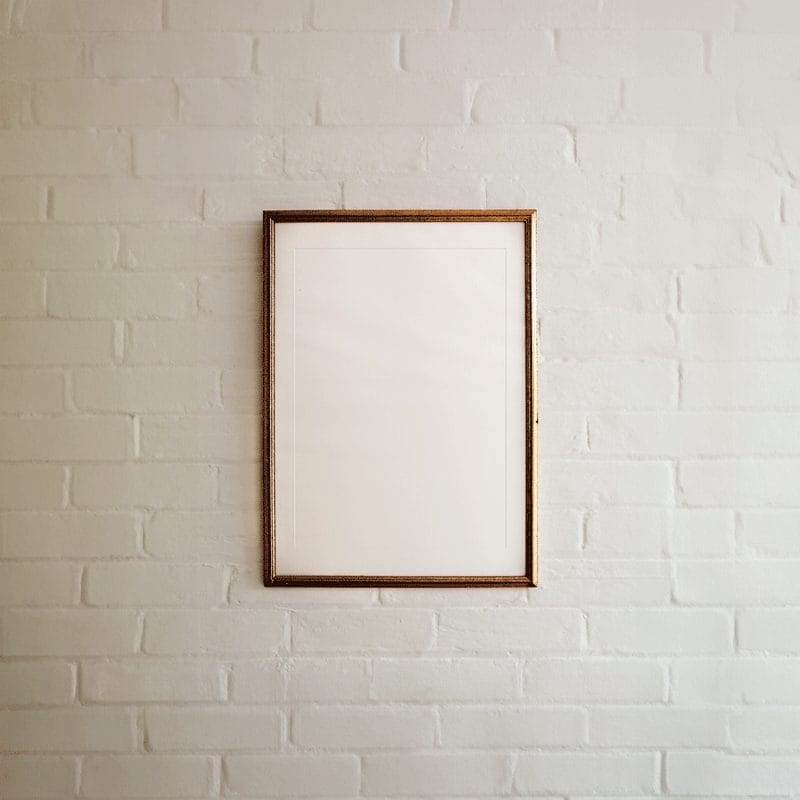 Metallic Frame on White Brick Wall Mockup PSD