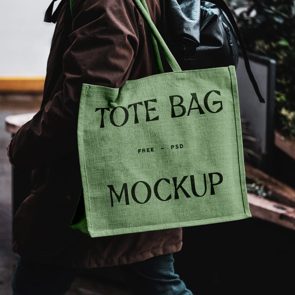 Free Eco Bag Carrying by Man Mockup PSD