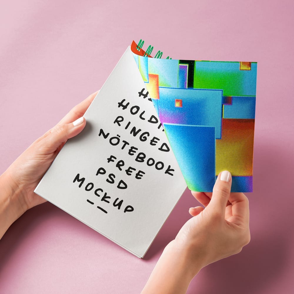 Free Hand Holding Ringed Notebook Mockup PSD