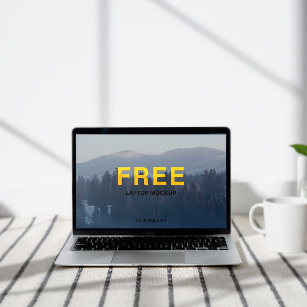 Free Laptop on a Table Mockup PSD