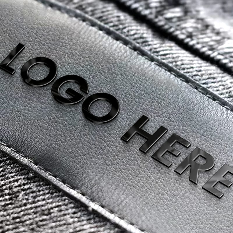 Black Metal Logo Mockup on Jeans Label PSD