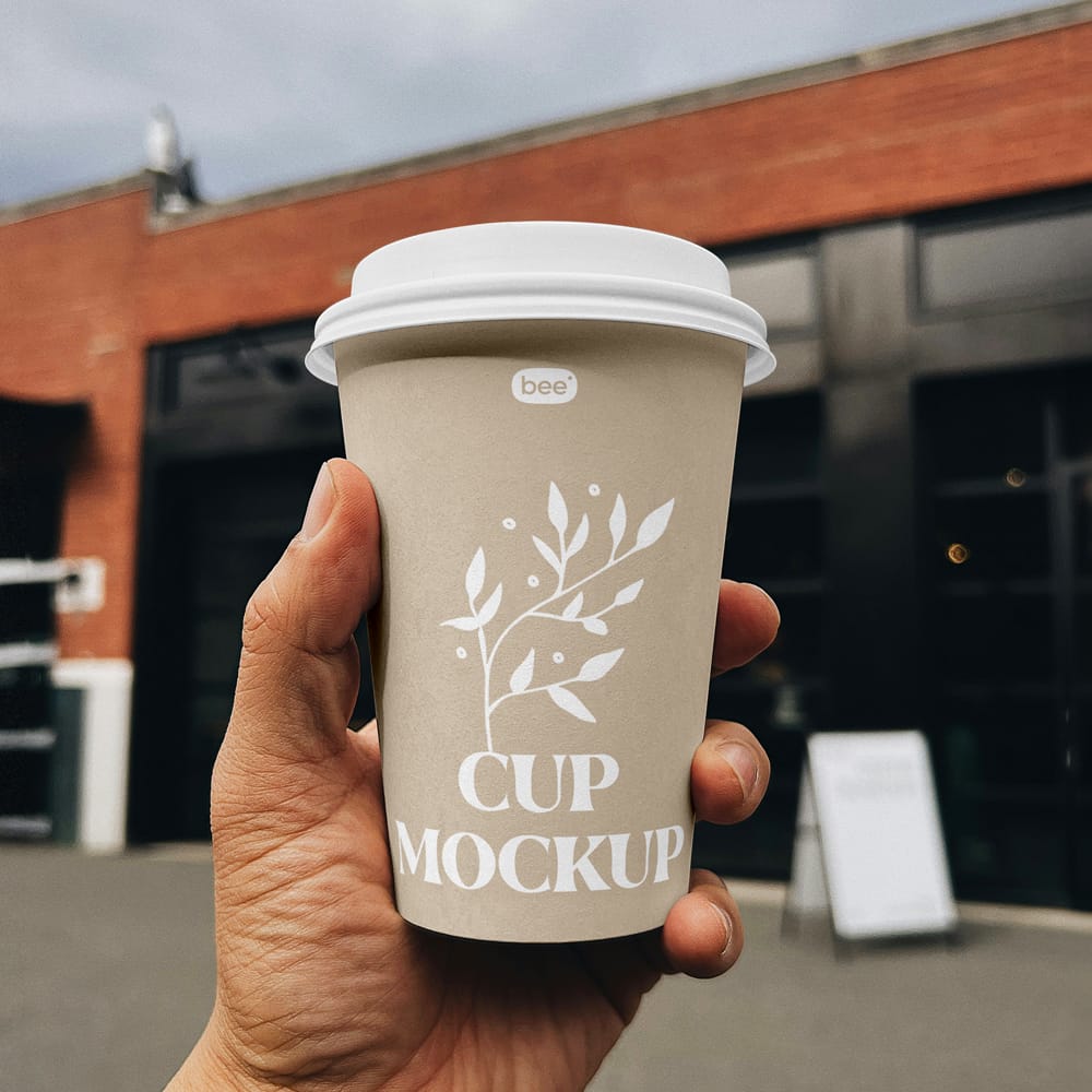 Free Big Paper Cup in Hand Mockup PSD