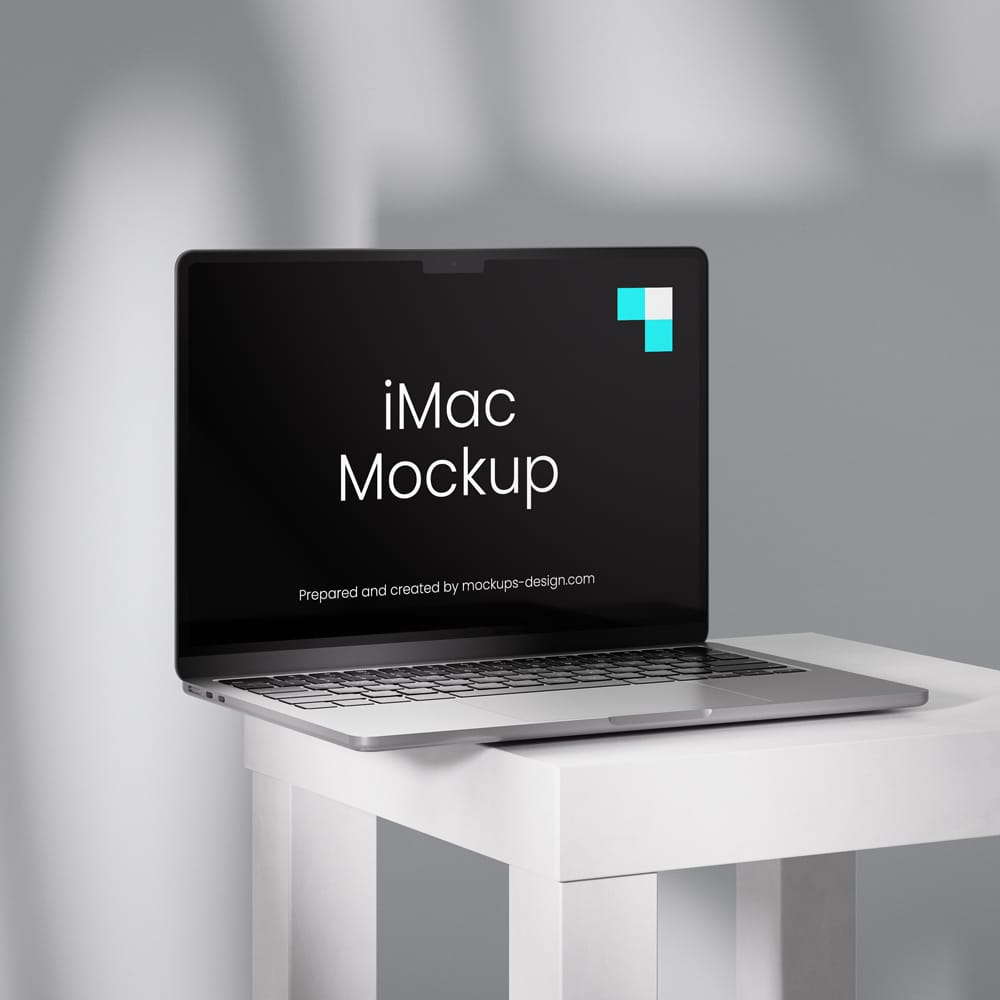 Free MacBook on a Table Mockup PSD