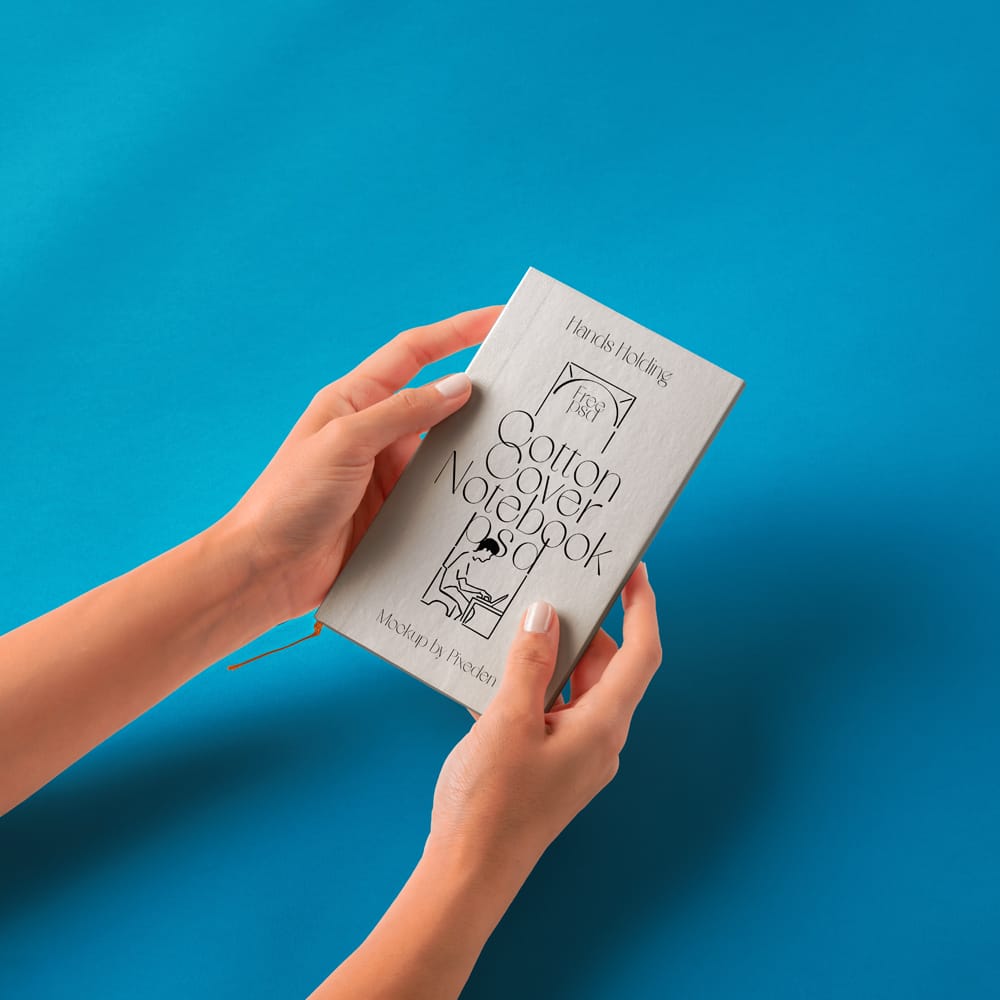 Free Hand Holding Cotton Notebook Mockup PSD